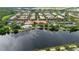 Wide aerial view of residential community with lakeside clubhouse, pool, and scenic surroundings at 12041 Kajetan Ln, Orlando, FL 32827