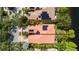 Aerial view of house with terracotta roof, solar panels, and lush landscaping at 12041 Kajetan Ln, Orlando, FL 32827