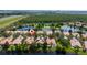 Aerial view of a lakeside community with houses featuring pools at 12041 Kajetan Ln, Orlando, FL 32827