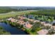 Aerial view showcasing a lakeside residential community surrounded by waterways and highway at 12041 Kajetan Ln, Orlando, FL 32827