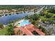 Aerial of community center, pool, parking and lush landscaping with lakeside views at 12041 Kajetan Ln, Orlando, FL 32827