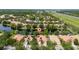 Community aerial view showcasing houses, trees, and a serene lake at 12041 Kajetan Ln, Orlando, FL 32827