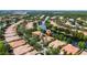 Aerial view of neighborhood with lake, lush trees, and well-maintained houses at 12041 Kajetan Ln, Orlando, FL 32827