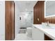 This modern bathroom features a glass enclosed shower with marble tile and wood accents at 12041 Kajetan Ln, Orlando, FL 32827