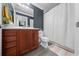 Bathroom with a wooden vanity, stylish gray flooring, and patterned shower curtain at 12041 Kajetan Ln, Orlando, FL 32827