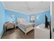 Light-filled bedroom features hardwood floors, a ceiling fan, and a modern desk space at 12041 Kajetan Ln, Orlando, FL 32827