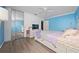 Cozy bedroom with a ceiling fan, hardwood floors, mirrored closet doors, and ample natural light at 12041 Kajetan Ln, Orlando, FL 32827