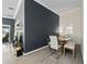 Modern dining area showcasing contemporary glass table and decorative wall accents at 12041 Kajetan Ln, Orlando, FL 32827