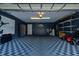 A spacious garage features checkered floors, shelving, a go-kart, and plenty of storage at 12041 Kajetan Ln, Orlando, FL 32827