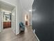 Hallway with an inviting gray bench seating featuring easy access to bathroom and kitchen areas at 12041 Kajetan Ln, Orlando, FL 32827