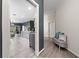Inviting hallway featuring stylish gray bench and accents leading to an open kitchen at 12041 Kajetan Ln, Orlando, FL 32827