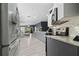 Modern kitchen with stainless steel appliances, granite countertops, and a view into the living area at 12041 Kajetan Ln, Orlando, FL 32827