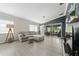 Bright living room with comfortable gray sofa, neutral colors, and sliding glass door to patio at 12041 Kajetan Ln, Orlando, FL 32827