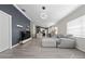 Open concept living space with stylish gray sofa and seamless flow to kitchen area at 12041 Kajetan Ln, Orlando, FL 32827