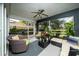 Comfortable sunroom with a ceiling fan, wicker furniture, and large windows with views of the back yard at 12041 Kajetan Ln, Orlando, FL 32827