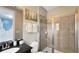 Bathroom featuring a tiled shower with glass door, granite vanity, and access to bedroom at 1228 Castle Pines Ct, Reunion, FL 34747