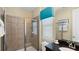 Bathroom with a single vanity and glass-enclosed shower at 1228 Castle Pines Ct, Reunion, FL 34747