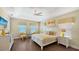Bright bedroom features a tray ceiling, ceiling fan, and decorative yellow accents at 1228 Castle Pines Ct, Reunion, FL 34747