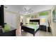 Welcoming bedroom with dark wood furniture, green accents, and tile floors at 1228 Castle Pines Ct, Reunion, FL 34747
