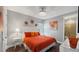 Comfortable bedroom with queen bed, decorative lamps, and a view to the bathroom at 1228 Castle Pines Ct, Reunion, FL 34747