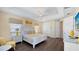 Bedroom features a tray ceiling, fan, and decoratively appointed furnishings and decor at 1228 Castle Pines Ct, Reunion, FL 34747