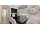 View of the dining area featuring a large dark table with seating for eight and dark wood cabinets at 1228 Castle Pines Ct, Reunion, FL 34747
