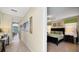 A view down a hallway with modern decor, a console table, and a glimpse into a bedroom at 1228 Castle Pines Ct, Reunion, FL 34747