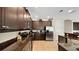 Well-equipped kitchen boasts dark wood cabinets, stainless steel appliances, and granite countertops at 1228 Castle Pines Ct, Reunion, FL 34747