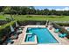 Resort-style pool and hot tub with brick patio, ample seating, and a lush golf course view at 1228 Castle Pines Ct, Reunion, FL 34747