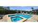 Backyard swimming pool and spa area with plenty of deck space for lounging and enjoying the Florida sun at 1228 Castle Pines Ct, Reunion, FL 34747