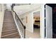An interior view of a staircase with dark metal railings and wood steps leading to the upper level at 1228 Castle Pines Ct, Reunion, FL 34747