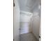 Walk-in closet provides ample storage space with wire shelving and tile flooring at 13940 Corrine Key Pl, Orlando, FL 32824