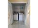 Conveniently located laundry closet featuring a washer and dryer for easy chores at 13940 Corrine Key Pl, Orlando, FL 32824