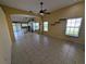 Bright living room with tile floors, ceiling fan, and views of the kitchen and sliding glass doors at 13940 Corrine Key Pl, Orlando, FL 32824