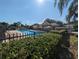 Community pool area with lounge chairs and a clubhouse, perfect for relaxation and socializing at 13940 Corrine Key Pl, Orlando, FL 32824