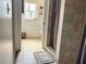 Tiled bathroom with view of the shower, commode and a window at 1425 Carey Glen Cir, Orlando, FL 32824