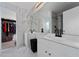 Bright bathroom featuring marble tile, double vanity, and an open walk-in closet at 1425 Carey Glen Cir, Orlando, FL 32824