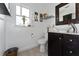 Bright bathroom featuring modern sink, dark wood vanity, and decorative wall art at 1425 Carey Glen Cir, Orlando, FL 32824