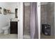 Bathroom with tiled shower, dark vanity, toilet, and stylish decor at 1425 Carey Glen Cir, Orlando, FL 32824