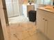 Bathroom with marble tile floors, white cabinets, dual sinks, and white doors at 1425 Carey Glen Cir, Orlando, FL 32824