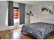 Bedroom featuring wood floors, gray drapes, a printed bedspread, and ample natural light at 1425 Carey Glen Cir, Orlando, FL 32824