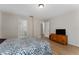 Comfortable bedroom with hardwood floors and a view of the doorway to the bathroom at 1425 Carey Glen Cir, Orlando, FL 32824