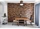 Dining room featuring a stone accent wall, modern light fixtures, and stylish decor at 1425 Carey Glen Cir, Orlando, FL 32824