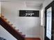 Entryway with hardwood stairs, artistic decor, and a black front door at 1425 Carey Glen Cir, Orlando, FL 32824