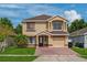 Charming two-story home with neutral paint, attached garage, and well-manicured lawn at 1425 Carey Glen Cir, Orlando, FL 32824