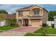 Two-story home featuring brick driveway and manicured lawn at 1425 Carey Glen Cir, Orlando, FL 32824