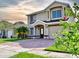 Inviting two-story home featuring a neatly landscaped yard and a spacious driveway at 1425 Carey Glen Cir, Orlando, FL 32824