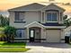 Charming two-story home with a well-manicured front yard and a paved driveway at 1425 Carey Glen Cir, Orlando, FL 32824