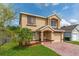 Inviting two-story home with a brick driveway, and a one car garage at 1425 Carey Glen Cir, Orlando, FL 32824