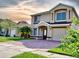 Charming two-story home with a well-maintained lawn and brick driveway; a great curb appeal at 1425 Carey Glen Cir, Orlando, FL 32824